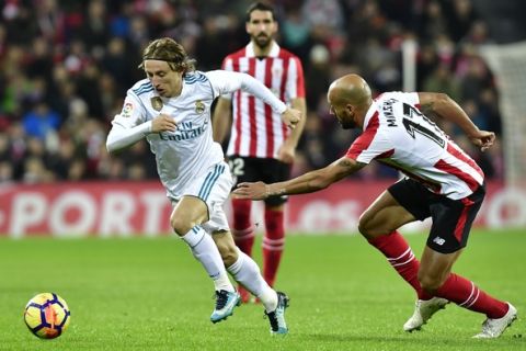 Athletic Bilbao's Mikel Rico, right, duels for the ball with Real Madrid's Luka Modric during the Spanish La Liga soccer match between Athletic Bilbao and Real Madrid at San Mames stadium, in Bilbao, northern Spain, Saturday, Dec. 2, 2017. (AP Photo/Alvaro Barrientos)