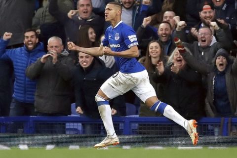 Everton's Richarlison celebrates scoring his side's first goal of the game , during the English Premier League soccer match between Everton and Chelsea at Goodison Park in Liverpool, England, Sunday March 17, 2019. (Martin Rickett/PA via AP)