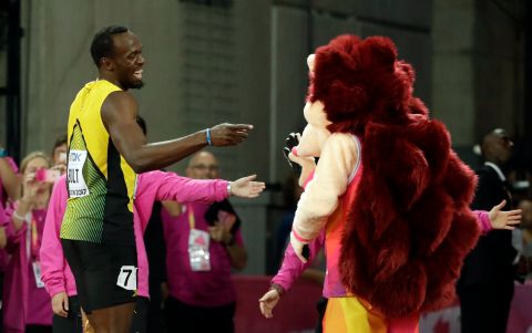 Jamaica's Usain Bolt jokes with mascot Hero the Hedgehog after his men's 100m heat during the World Athletics Championships in London Friday, Aug. 4, 2017. (AP Photo/Matthias Schrader)