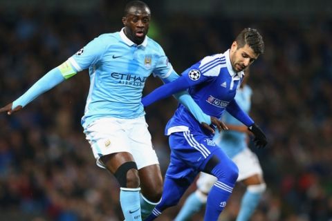 "MANCHESTER, ENGLAND - MARCH 15:  Yaya Toure of Manchester City holds off Miguel Veloso of Dynamo Kiev during the UEFA Champions League round of 16 second leg match between Manchester City FC and FC Dynamo Kyiv at the Etihad Stadium on March 15, 2016 in Manchester, United Kingdom.  (Photo by Alex Livesey/Getty Images)"