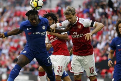Chelsea's Michy Batshuayi, left, and Arsenal's Nacho Monreal challenge for the ball during the English Community Shield soccer match between Arsenal and Chelsea at Wembley Stadium in London, Sunday, Aug. 6, 2017. (AP Photo/Frank Augstein)