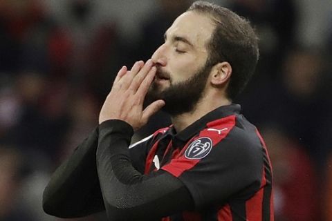 AC Milan's Gonzalo Higuain gestures after missing a scoring chance during a Serie A soccer match between AC Milan and Torino , at the San Siro stadium in Milan, Italy, Sunday, Dec. 9, 2018. (AP Photo/Luca Bruno)