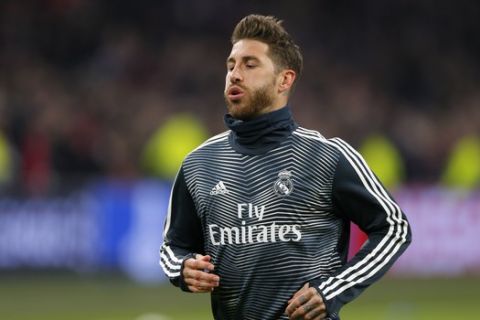 Real defender Sergio Ramos warms up during the first leg, round of sixteen, Champions League soccer match between Ajax and Real Madrid at the Johan Cruyff ArenA in Amsterdam, Netherlands, Wednesday Feb. 13, 2019. (AP Photo/Peter Dejong)