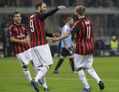 AC Milan's Fabio Borini, right, celebrates with teammate Gonzalo Higuain after scoring his team's fifth goal during the Europa League soccer match between AC Milan and F-91 Dudelange at the San Siro Stadium, in Milan, Italy, Thursday, Nov. 29, 2018. (AP Photo/Luca Bruno)