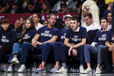Fans in matching shirts watch a game between the Brooklyn Nets and the Indiana Pacers during the second half of an NBA basketball game Monday, Oct. 31, 2022, in New York. (AP Photo/Jessie Alcheh)