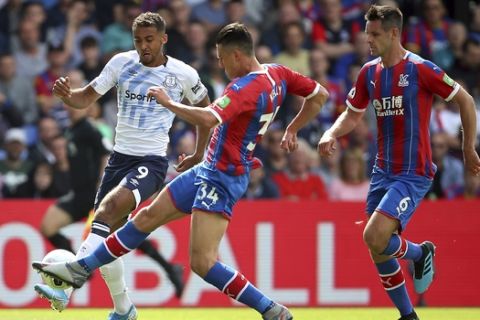 Everton's Dominic Calvert-Lewin, left, and Crystal Palace's Martin Kelly compete for the ball during the English Premier League soccer match between Crystal Palace and Everton at Selhurst Park stadium, London, England. Saturday, Aug, 10 2019. (Nigel French/PA via AP)