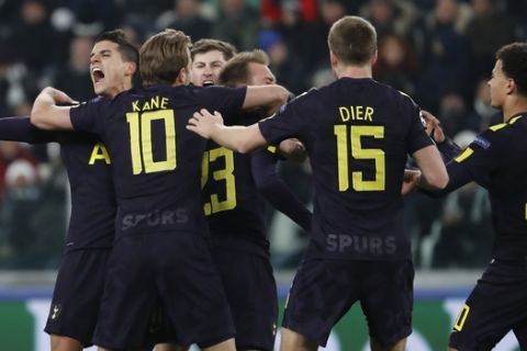 Tottenham's Christian Eriksen, 4th from right, celebrates with teammates after scoring his side's second goal during the Champions League, round of 16, first-leg soccer match between Juventus and Tottenham Hotspurs, at the Allianz Stadium in Turin, Italy, Tuesday, Feb. 13, 2018. (AP Photo/Antonio Calanni)