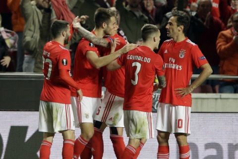 Benfica's Francisco Ferreira, second left, celebrates with teammates after scoring his side's second goal during the Europa League round of 16, second leg, soccer match between Benfica and Dinamo Zagreb at the Luz stadium in Lisbon, Thursday, March 14, 2019. (AP Photo/Armando Franca)