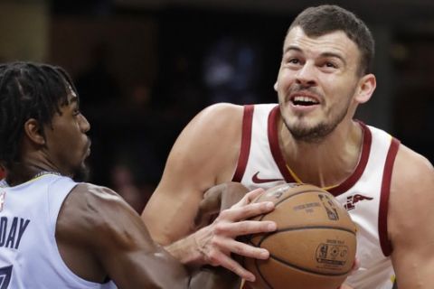 Cleveland Cavaliers' Ante Zizic (41), from Croatia, drives to the basket against Memphis Grizzlies' Justin Holiday (7) in the first half of an NBA basketball game, Saturday, Feb. 23, 2019, in Cleveland. (AP Photo/Tony Dejak)