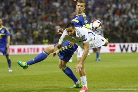 Bosnia's Edin Dzeko, right, and Greece's Kostas Manolas, fight for the ball during their World Cup Group H qualifying match at the Bilino Polje Stadium in Zenica on Friday, June 9, 2017. (AP Photo/Amel Emric)