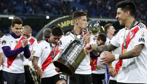 Players of Argentina's River Plate celebrate with the Copa Libertadores trophy after defeating 3-1 Boca Juniors in the final match at the Santiago Bernabeu stadium in Madrid, Spain, Sunday, Dec. 9, 2018. (AP Photo/Manu Fernandez)