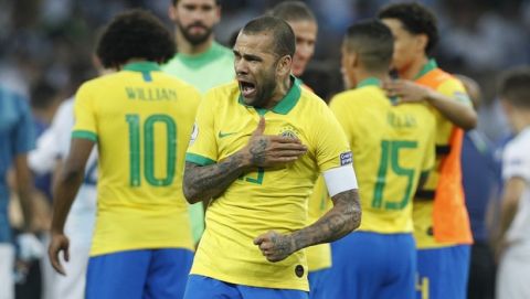 Brazil's Dani Alves celebrates his team's 2-0 victory over Argentina at the end of their Copa America semifinal soccer match at Mineirao stadium in Belo Horizonte, Brazil, Tuesday, July 2, 2019. (AP Photo/Victor R. Caivano)