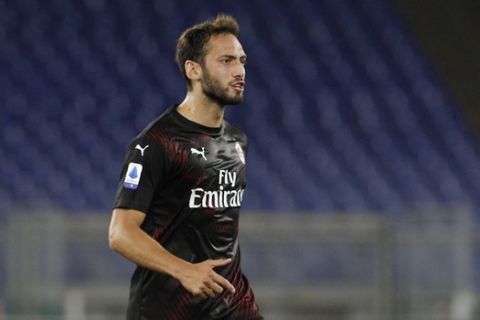 AC Milan's Hakan Calhanoglu celebrates after scoring his side's opening goal during the Serie A soccer match between Lazio and AC Milan at the Rome Olympic stadium, Saturday, July 4, 2020. (AP Photo/Riccardo De Luca)
