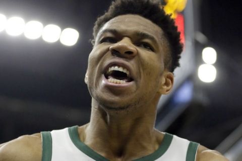 Milwaukee Bucks' Giannis Antetokounmpo reacts after a dunk during the second half of the team's NBA basketball game against the Washington Wizards on Wednesday, Feb. 6, 2019, in Milwaukee. (AP Photo/Aaron Gash)