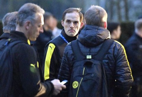 Dortmund head coach Thomas Tuchel stands outside the team bus after it was damaged in an explosion before the Champions League quarterfinal soccer match between Borussia Dortmund and AS Monaco in Dortmund, western Germany, Tuesday, April 11, 2017.  (AP Photo/Martin Meissner)