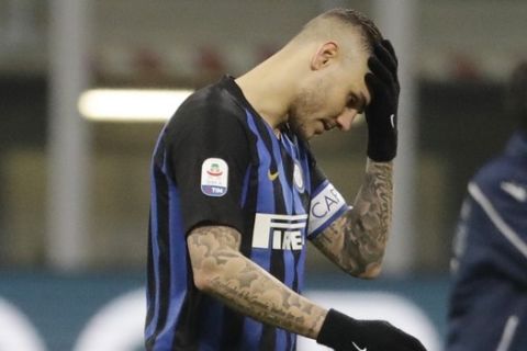 FILE - In this Sunday, Feb. 3, 2019 file photo, Inter Milan's Mauro Icardi walks off the pitch at the end of a Serie A soccer match between Inter Milan and Bologna, at the San Siro stadium in Milan, Italy. Inter is firmly in its mid-season slump and failure to win at Parma on Saturday would deepen the Nerazzurri crisis. The players left the field to deafening jeers from their own fans after Sunday's 1-0 defeat at home to relegation-threatened Bologna to pile more pressure on coach Luciano Spalletti, amid speculation the club is preparing to replace him with Antonio Conte. Inter CEO Giuseppe Marotta has denied Spallettis job is at risk but the clubs grip on a Champions League place is weakening. (AP Photo/Luca Bruno, File)