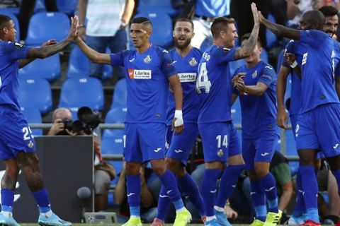 Getafe's players celebrate after scoring their side's first goal during Europe League Group C soccer match between Getafe and Trabzonspor at the Alfonso Perez stadium in Getafe, Spain, Thursday, Sept. 19, 2019. (AP Photo/Manu Fernandez)