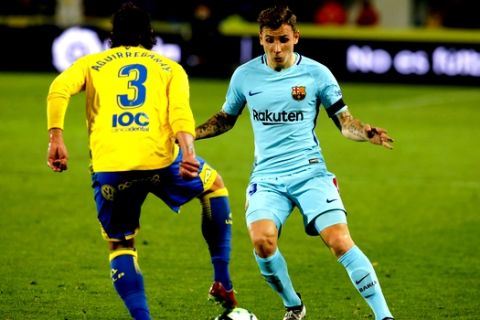 CORRECTING YEAR TO 2018 - FC Barcelona's Lucas Digne, right, duels for the ball with Las Palmas' Matias Aguirregaray during a Spanish La liga soccer match at the Gran Canaria stadium in the Canary island of Las Palmas, Thursday March 1, 2018. (AP Photo/Lucas de Leon)