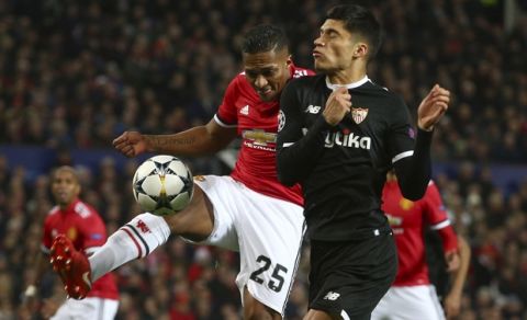 Sevilla's Joaquin Correa, right, and Manchester United's Antonio Valencia vie for the ball during the Champions League round of 16 second leg soccer match between Manchester United and Sevilla, at Old Trafford in Manchester, England, Tuesday, March 13, 2018. (AP Photo/Dave Thompson)