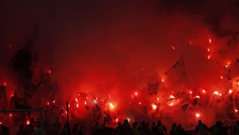 Fans set off flares at the start of the Europa League Final soccer match between Marseille and Atletico Madrid at the Stade de Lyon in Decines, outside Lyon, France, Wednesday, May 16, 2018. (AP Photo/Francois Mori)