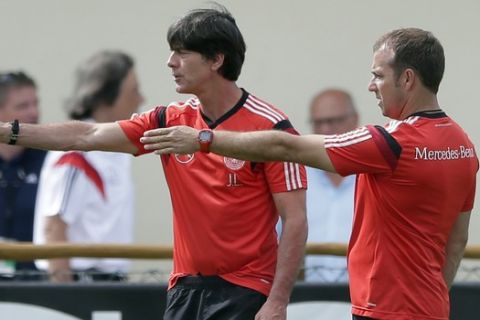German national soccer team head coach Joachim Loew, left, and assistant Hansi Flick arrive for a training session in Santo Andre near Porto Seguro, Brazil, Saturday, June 14, 2014. Germany will play in group G of the 2014 soccer World Cup. (AP Photo/Matthias Schrader)