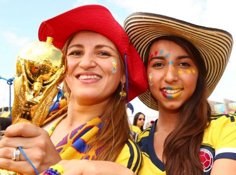 BELO HORIZONTE, BRAZIL - JUNE 14:  Colombia fans enjoy the atmosphere while holding a replica of the World Cup trophy prior to the 2014 FIFA World Cup Brazil Group C match between Colombia and Greece at Estadio Mineirao on June 14, 2014 in Belo Horizonte, Brazil.  (Photo by Ian Walton/Getty Images)