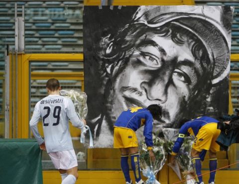 Lazio's Lorenzo De Silvestri, left, Parma's Fernando Couto and Bernardo Corradi lay bouquets of flowers next to a picture of Gabriele Sandri, the Lazio supporter who was shot to death by a police officer, prior to the kick-off of the Italian Top League soccer match beetween Lazio and Parma, at Rome's Olympic Stadium, Sunday, Nov. 25, 2007. (AP Photo/Alessandra Tarantino)