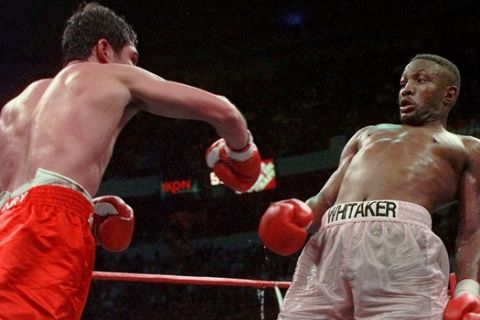 Pernell Whitaker, right, leans away from a punch by Oscar De La Hoya during their WBC Welterweight Championship fight at Thomas & Mack Center in Las Vegas, Saturday, April 12, 1997. De La Hoya won by unanimous decision. (AP Photo/Eric Draper)