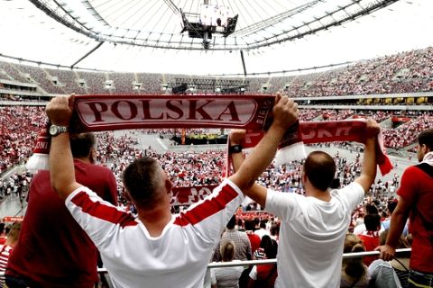 Fans gather at the National Stadium which turned to a giant fanzone, to watch on videowalls the group H match between Poland and Senegal at the 2018 soccer World Cup in Russia, in Warsaw, Poland, Tuesday, June 19, 2018. (AP Photo/Alik Keplicz)