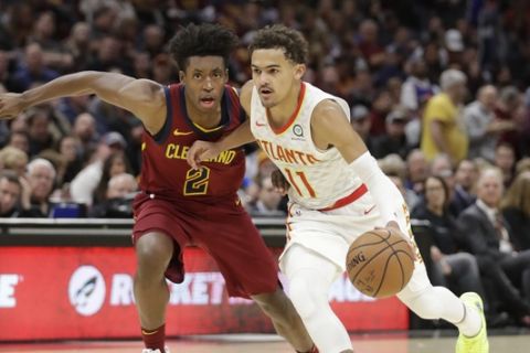 Atlanta Hawks' Trae Young (11) drives past Cleveland Cavaliers' Collin Sexton (2) in the second half of an NBA basketball game, Sunday, Oct. 21, 2018, in Cleveland. The Hawks won 133-111. (AP Photo/Tony Dejak)