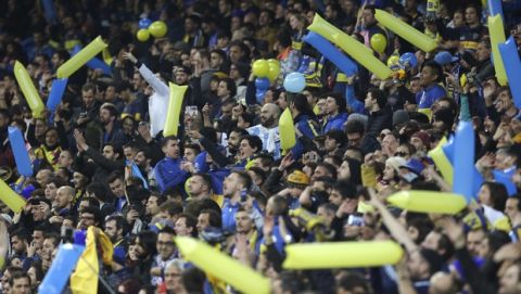 Boca Juniors fans cheer during a Copa Libertadores final soccer match between River Plate and Boca Juniors at the Santiago Bernabeu stadium in Madrid, Spain, Sunday, Dec. 9, 2018. (AP Photo/Armando Franca)