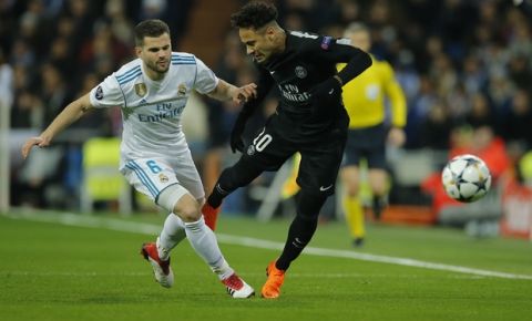 Real Madrid's Nacho is fouled by PSG's Neymar, right,during the Champions League soccer match, round of 16, 1st leg between Real Madrid and Paris Saint Germain at the Santiago Bernabeu stadium in Madrid, Spain, Wednesday, Feb. 14, 2018. (AP Photo/Paul White)