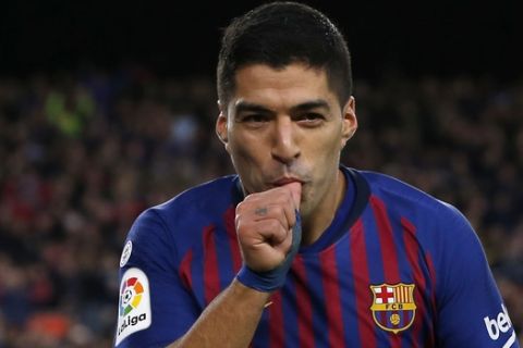 Barcelona forward Luis Suarez celebrates after scoring his side's fourth goal during the Spanish La Liga soccer match between FC Barcelona and Real Madrid at the Camp Nou stadium in Barcelona, Spain, Sunday, Oct. 28, 2018. (AP Photo/Joan Monfort)