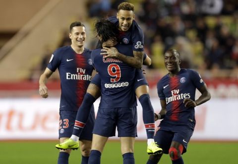 PSG's Edinson Cavani, center, celebrates with teammate Neymar, top center, after scoring his side's first goal of the game during the French League One soccer match between AS Monaco and Paris Saint-Germain at Stade Louis II in Monaco, Sunday, Nov. 11, 2018 (AP Photo/Claude Paris)