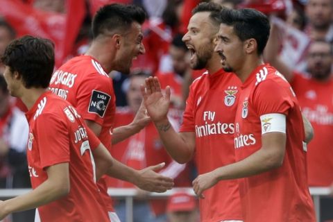 Benfica's Haris Seferovic, 2nd right, celebrates after scoring the opening goal during a Portuguese league last round soccer match between Benfica and Santa Clara at the Luz stadium in Lisbon, Saturday, May 18, 2019. (AP Photo/Armando Franca)