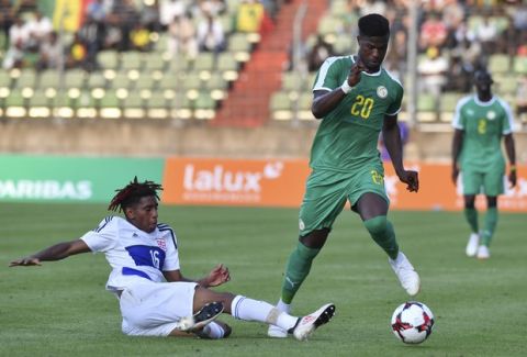 Luxembourg's Leandro Barreiro, left, tackles Senegal's Keita Balde during a friendly soccer match between Luxembourg and Senegal at the Josy Barthel stadium in Luxembourg, Thursday, May 31, 2018. (AP Photo/Geert Vanden Wijngaert)