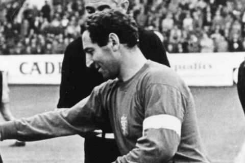 Captain of Switzerland Rene Brodmann, left, shakes hands and exchanges pennants with the captain of Spain, Francisco Gento, before the start of their Football World Cup match at Hillsborough , Sheffield, on July 15, 1966. Spain defeated Switzerland 2-1. (AP Photo/Bippa)