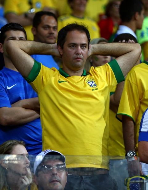 BELO HORIZONTE, BRAZIL - JULY 08: A dejected Brazil fan looks on during the 2014 FIFA World Cup Brazil Semi Final match between Brazil and Germany at Estadio Mineirao on July 8, 2014 in Belo Horizonte, Brazil.  (Photo by Michael Steele/Getty Images)