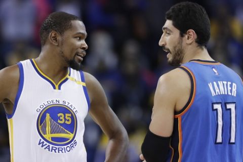 Golden State Warriors' Kevin Durant (35) talks to Oklahoma City Thunder's Enes Kanter (11) during the first half of an NBA basketball game Wednesday, Jan. 18, 2017, in Oakland, Calif. (AP Photo/Marcio Jose Sanchez)