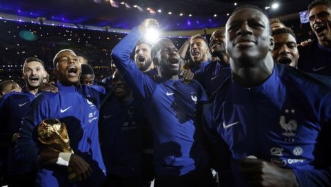 French soccer players celebrate with the World Cup trophy during a ceremony after the UEFA Nations League soccer match between France and The Netherlands at the Stade de France stadium in Saint-Denis, outside Paris, France, Sunday, Sept. 9, 2018. (AP Photo/Christophe Ena)