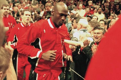 Chicago Bulls Guard Michael Jordan, center, joins his team as they enter Market Square Arena for their game with the Indiana Pacers, Sunday, March 19, 1995, Indianapolis, In. This game marked Jordan's return to the NBA after nearly 18 months. (AP Photo/Michael Conroy)