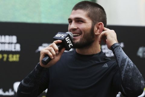 Russian UFC fighter Khabib Nurmagomedov gestures to the crowd during an open training session at Yas Mall in Abu Dhabi, United Arab Emirates, Wednesday, Sept. 4, 2019. Fighters Dustin Poirier and Khabib Nurmagomedov will face each other in UFC 242, which will be held Saturday, Sept. 7, 2019, in Abu Dhabi. Nurmagomedov did not spar during the open training, saying he was still trying to make weight for the bout. (AP Photo/Jon Gambrell)