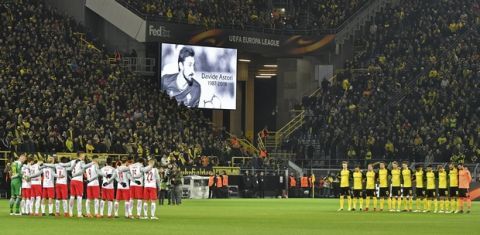 The stadium holds a minute of silence for Davide Astori prior the Europa League soccer match between Borussia Dortmund and FC Salzburg in Dortmund, Germany, Thursday, March 8, 2018. (AP Photo/Martin Meissner)