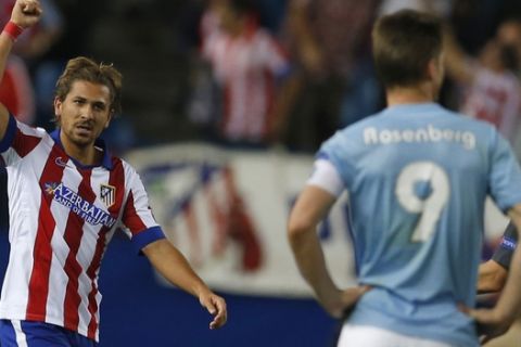 Atletico's Alessio Cerci, left, gestures after scoring his team's fifth goal.  during a Group A Champions League match between Atletico de Madrid and Malmo at the Vicente Calderon stadium in Madrid, Spain, Wednesday Oct. 22, 2014. Atletico de Madrid won 5-0. (AP Photo/Paul White)