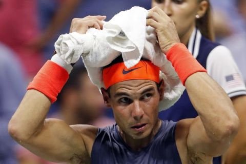 Rafael Nadal, of Spain, sits during a changeover in his match against Dominic Thiem, of Austria, during the quarterfinals of the U.S. Open tennis tournament early Wednesday, Sept. 5, 2018, in New York. (AP Photo/Adam Hunger)