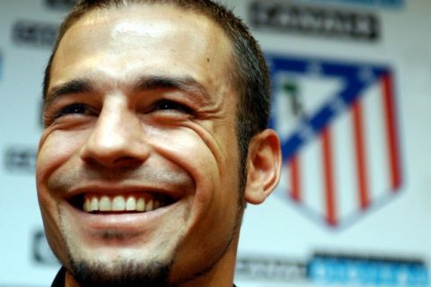 New Atletico de Madrid signing up Greece soccer player Demis Nikolaidis smiles while adressing a press briefing during the oficial presentation to media at the Calderon stadium in Madrid, Tuesday 22 July 2003. Nikolaidis played for the AEK.  EPA PHOTO/EFE/EMILIO NARANJO