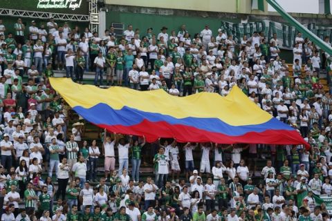 Supporters of Brazil's Chapecoense hold a Colombian flag prior to a Recopa Sudamericana first leg final soccer match between Chapecoense and Colombia's Atletico Nacional in Chapeco, Brazil, Tuesday, April 4, 2017. (AP Photo/Andre Penner)