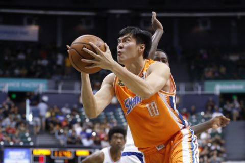 Shanghai Sharks center Dong Hanlin (10) goes to the basket during the first half of the NBA exhibition basketball game against the Los Angeles Clippers, Sunday, Oct. 6, 2019, in Honolulu. (AP Photo/Marco Garcia)