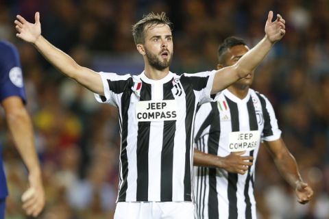 Juventus' Miralem Pjanic reacts to a referee decision during a Champions League group D soccer match between FC Barcelona and Juventus at the Camp Nou stadium in Barcelona, Spain, Tuesday, Sept. 12, 2017. (AP Photo/Francisco Seco)