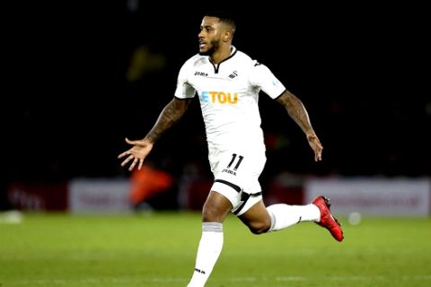 Swansea City's Luciano Narsingh celebrates scoring his side's second goal against Watford during the English Premier League soccer match at Vicarage Road, London, Saturday Dec. 30, 2017. (Nigel French/PA via AP)